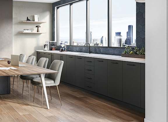 A modern kitchen with a dining table and chairs.