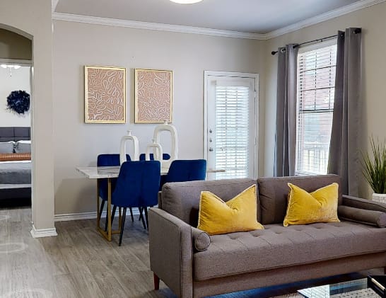A living room with a couch, chairs, and a coffee table.
