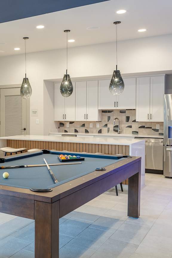 a game room with a pool table and a fireplace at Arbour Place Apartments, Jeffersonville, 47130