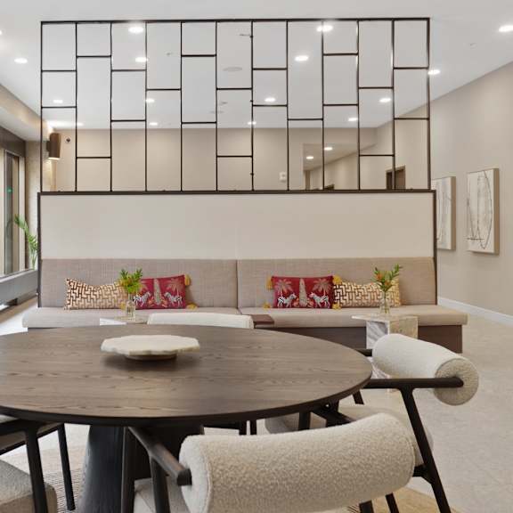 A modern living room with a fireplace and a long table.