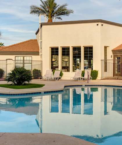 A pool with a building behind it.