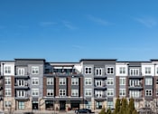 Thumbnail 28 of 31 - an image of an apartment building overlooking a parking lot