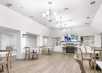 a dining room with tables and chairs and a tv