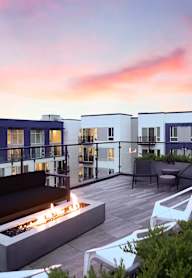 Paceline Apartments Rooftop Firepit and Seating Area at Sunset