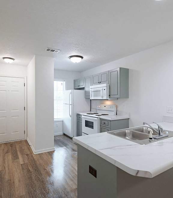 an open kitchen and dining area with a marble counter top at Sterlington Apartments, Grovetown, GA, 30813