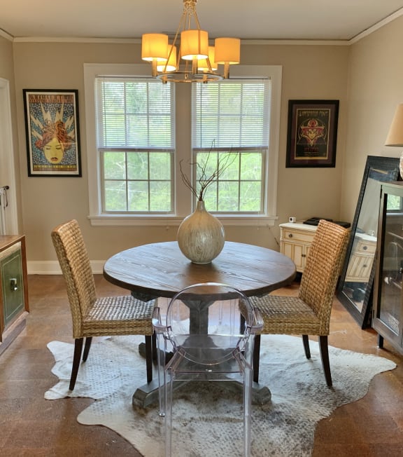 a dining room with a table and chairs and a chandelier