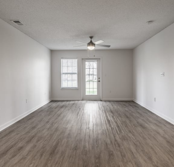 a room with a large window and plank flooring Indinapolis, IN