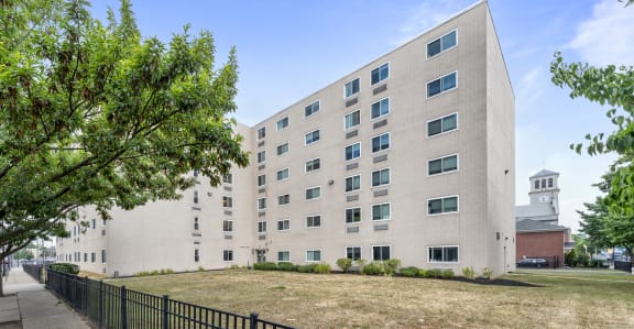 a large white building with a fence in front of it