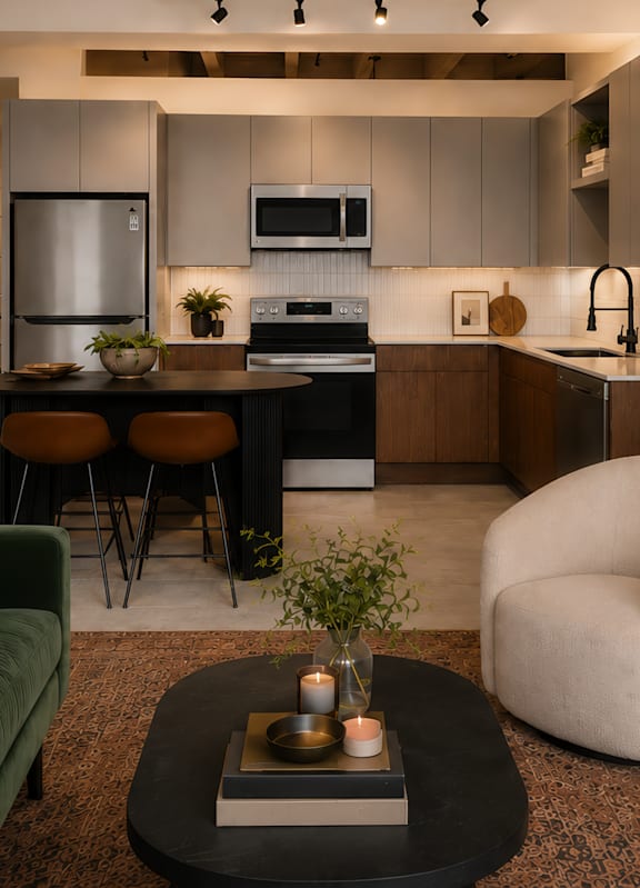 A modern living room with a green couch and a coffee table with candles on it.