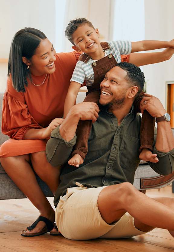A family of three is having fun in their living room.