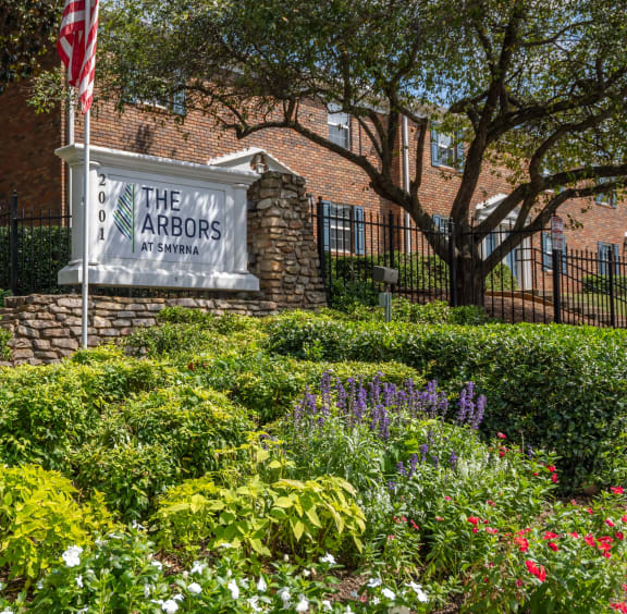 a building with a sign and a flag in front of it