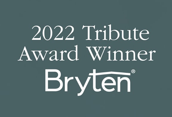 A dark green background with the text "2022 Tribute Award Winner Bryten" displayed in white.