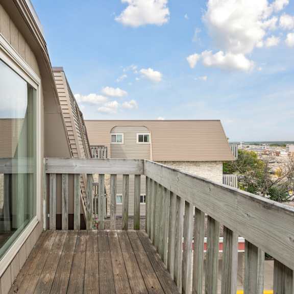 Private balcony with wooden deck and railings at Cedarvale Highlands Apartments, Eagan, 55122