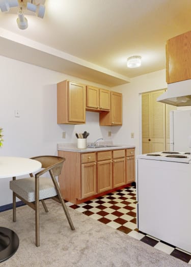 a living room with white walls and a large window at The Park Apartments in Minneapolis, MN