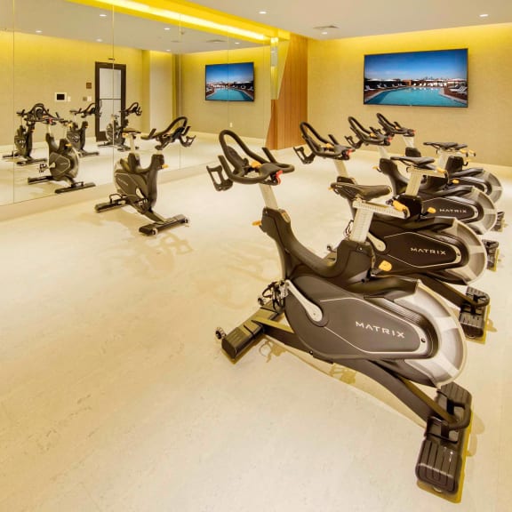a gym full of exercise bikes at The Enclave, Jersey City, New Jersey