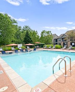 Pool with relaxing chairs at Stonepost Ranch Apartments, Overland Park, Kansas