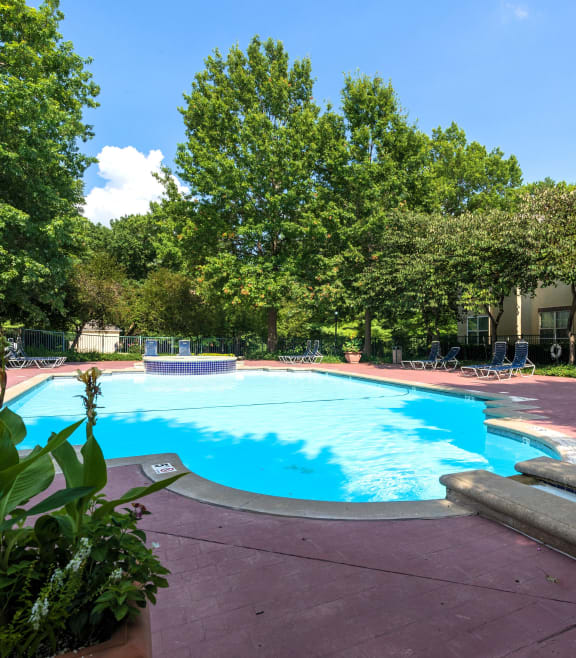 A sparkling pool with lounge chairs and umbrellas for a relaxing afternoon.