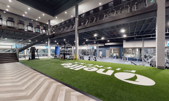 the gym has a lawn with a large white logo on it