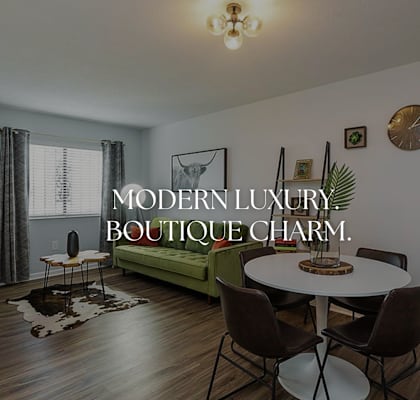 a living room with a table and a couch at Capital Flats & Magnolia Square Apartments, North Carolina, 27601