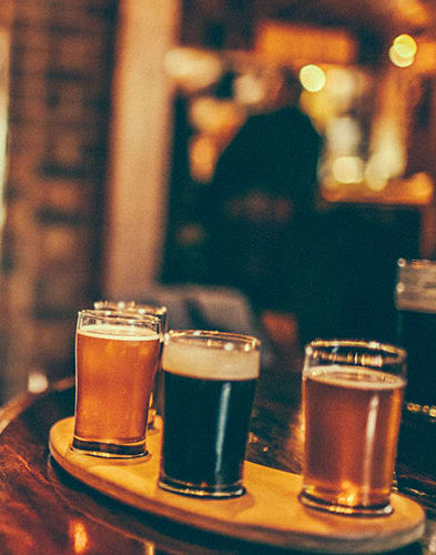 a selection of beers on a table in a bar