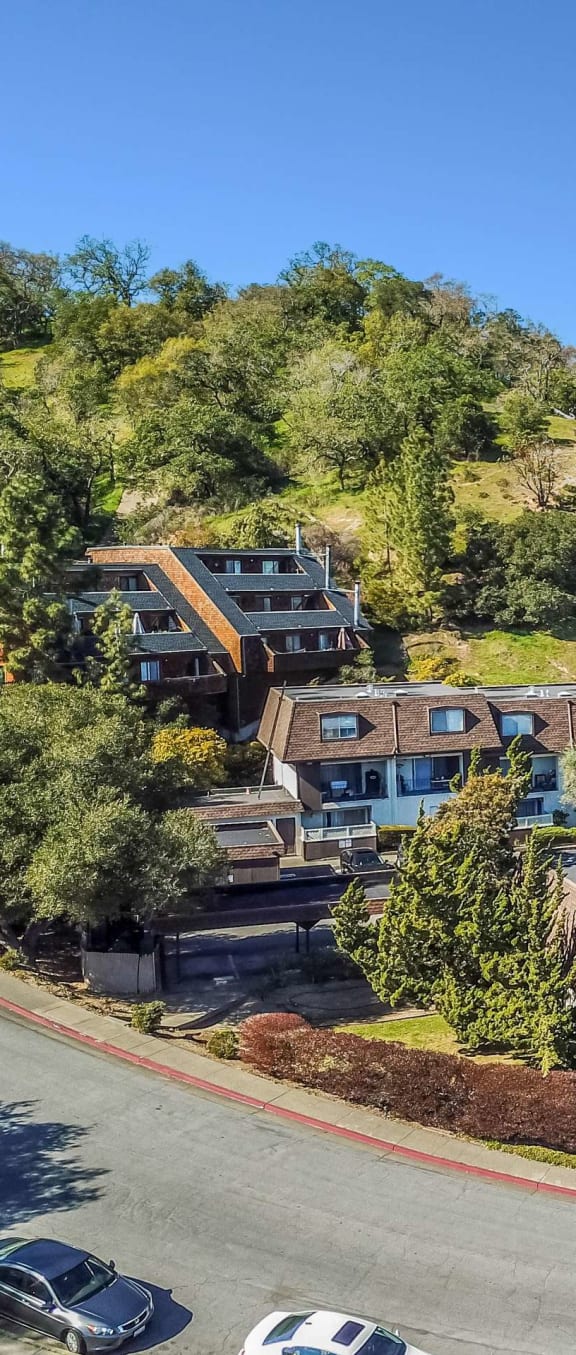 aerial view of apartment buildings and hillside