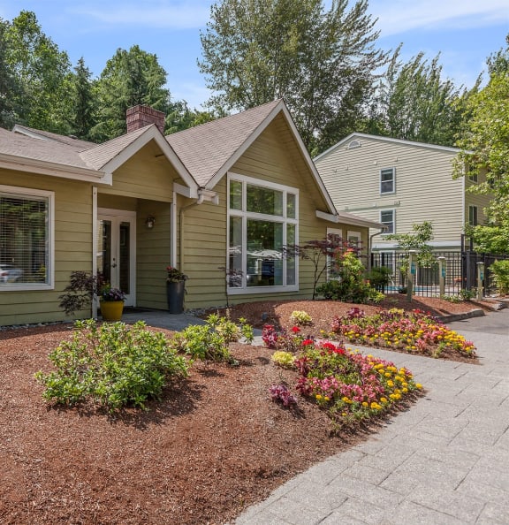 a house with a flower garden in front of it