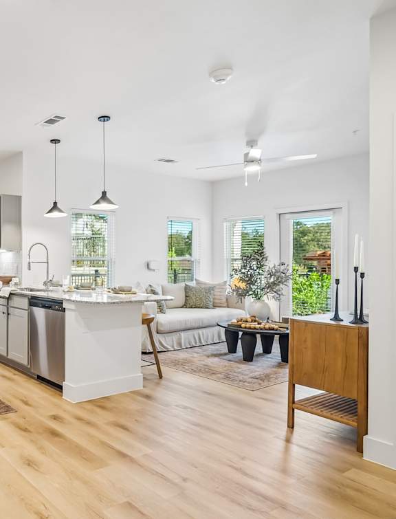 A modern kitchen with wooden floors and white walls.