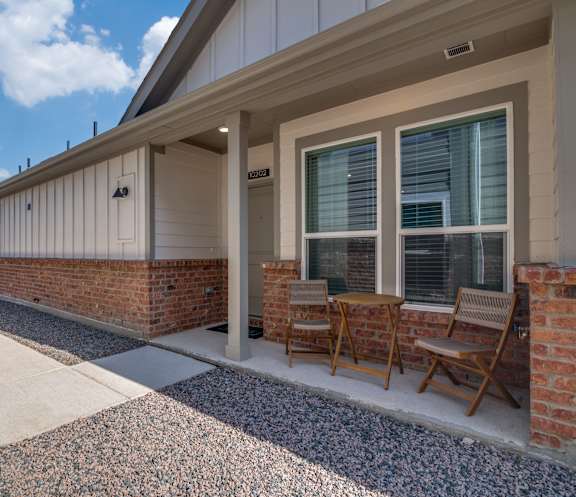 A house with a patio and chairs.