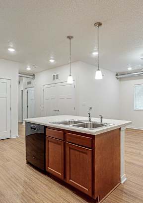 A kitchen with a sink and a refrigeratorat Melbourne Apartments, Iowa, 50320