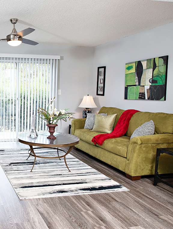 A living room with a yellow couch and a zebra print chair.