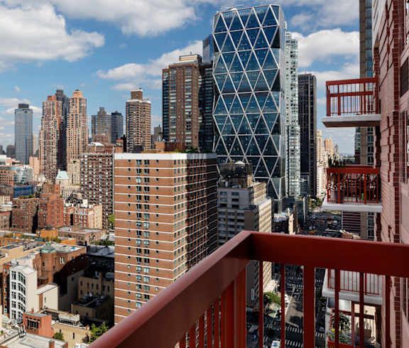 A cityscape with a mix of modern and older buildings, viewed from a high vantage point. at The Ellington Apartments, New York, 10019