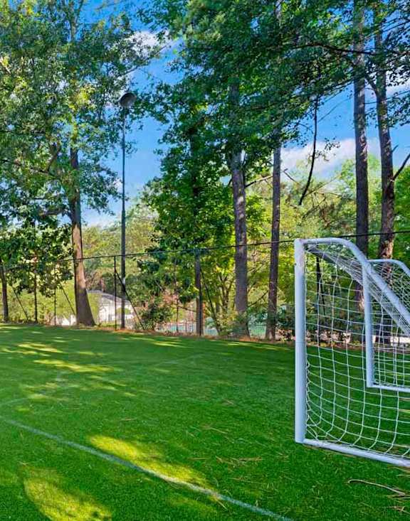 A soccer field with a goal post on the right side.