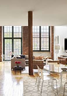 a living room with a table and chairs and a large window