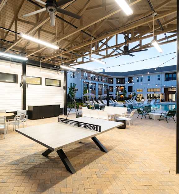 A large open patio with a table and chairs.