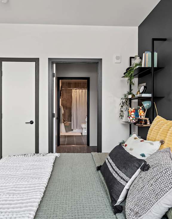 A bedroom with a bed and a painting on the wall.