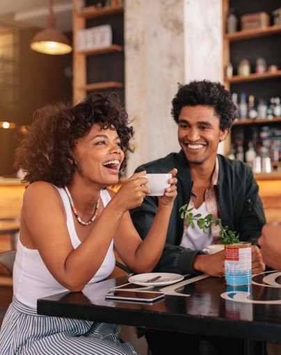 Four people are sitting at a table in a restaurant at 46Eleven Apartments, Dallas, TX, 75228