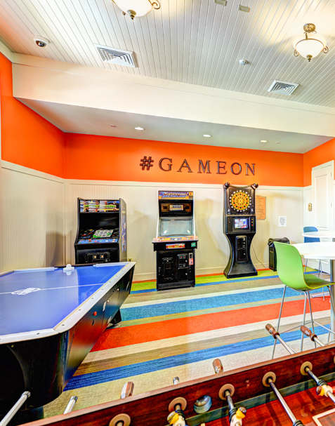 A gym with a variety of equipment including a rowing machine, a treadmill, and a stationary bike.