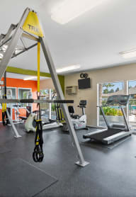 a room with gym equipment and two treadmills. at Terramonte Apartment Homes, California, 91767