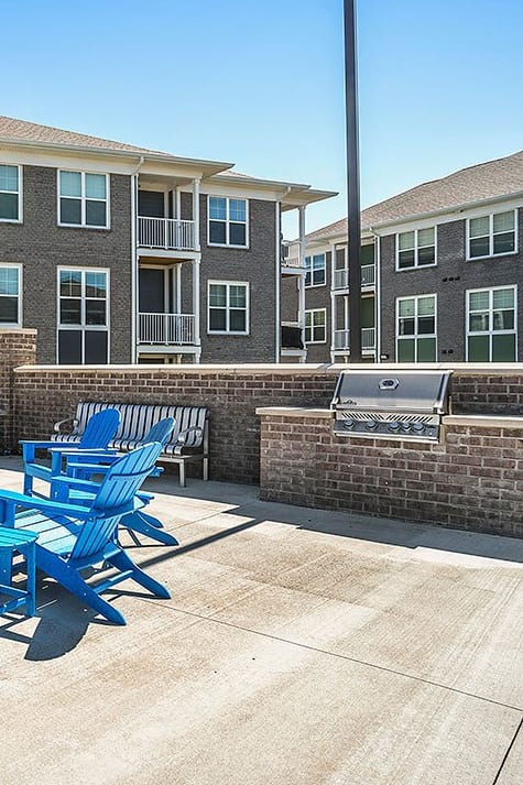 a swimming pool with lounge chairs and a fence around it