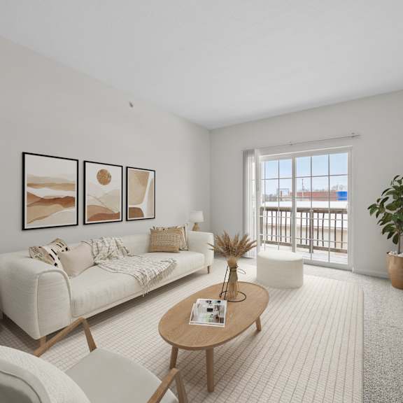 A living room with a white sofa, a wooden coffee table, and a white chair.