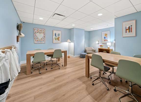 A room with a long table and chairs.