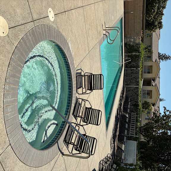 A small pool with a fountain in the middle.
