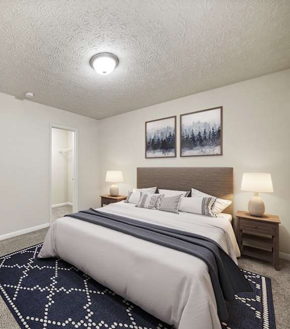 A bedroom with a large bed and a nightstand with a lamp at 445 Cleveland Apartments in Atlanta, Georgia,