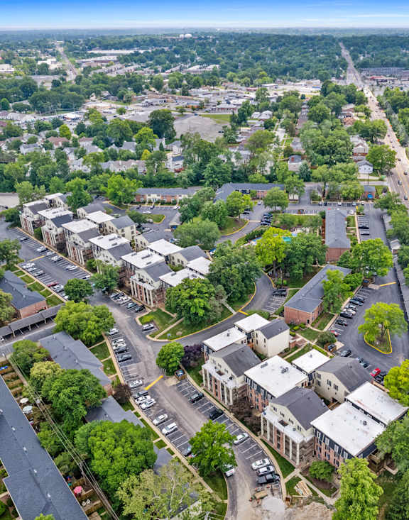 an aerial view of a city with houses and a highway