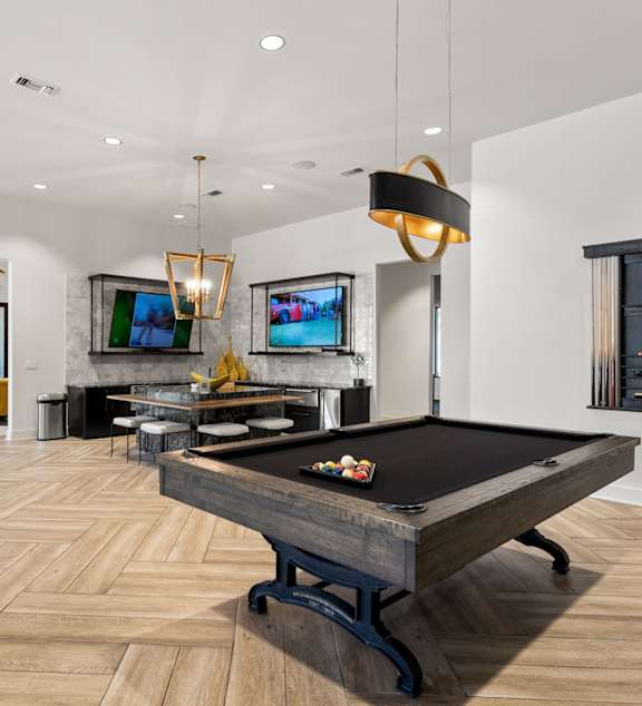 A kitchen with dark wood cabinets and granite countertops. at The Royce at 8100, Austin, TX, 78729