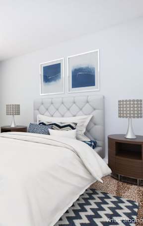 A bedroom with a large bed and two lamps.
