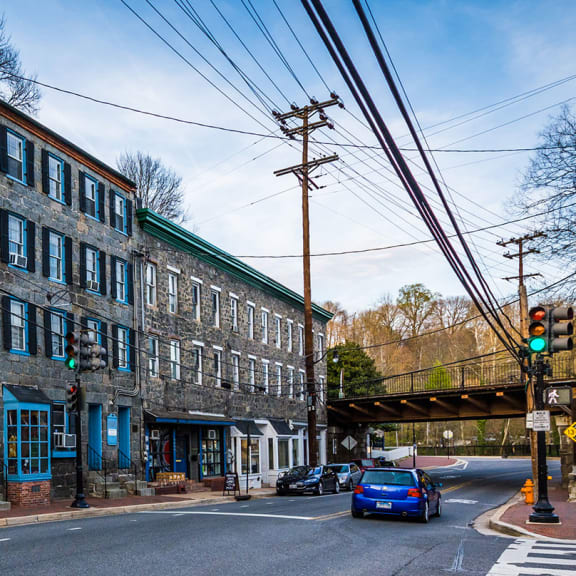 a city street with a large brick building on the side of the road  at Ellicott Grove, Ellicott City