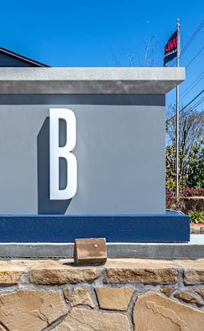 a sign with a b on it in front of a building