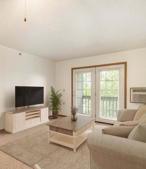 A living room with a television and a couch.