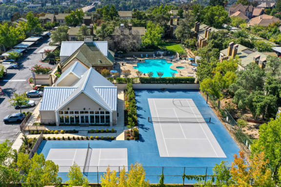 Drone View of Community showcasing the sports court areas and pool area in the distance at Folsom Ranch, California